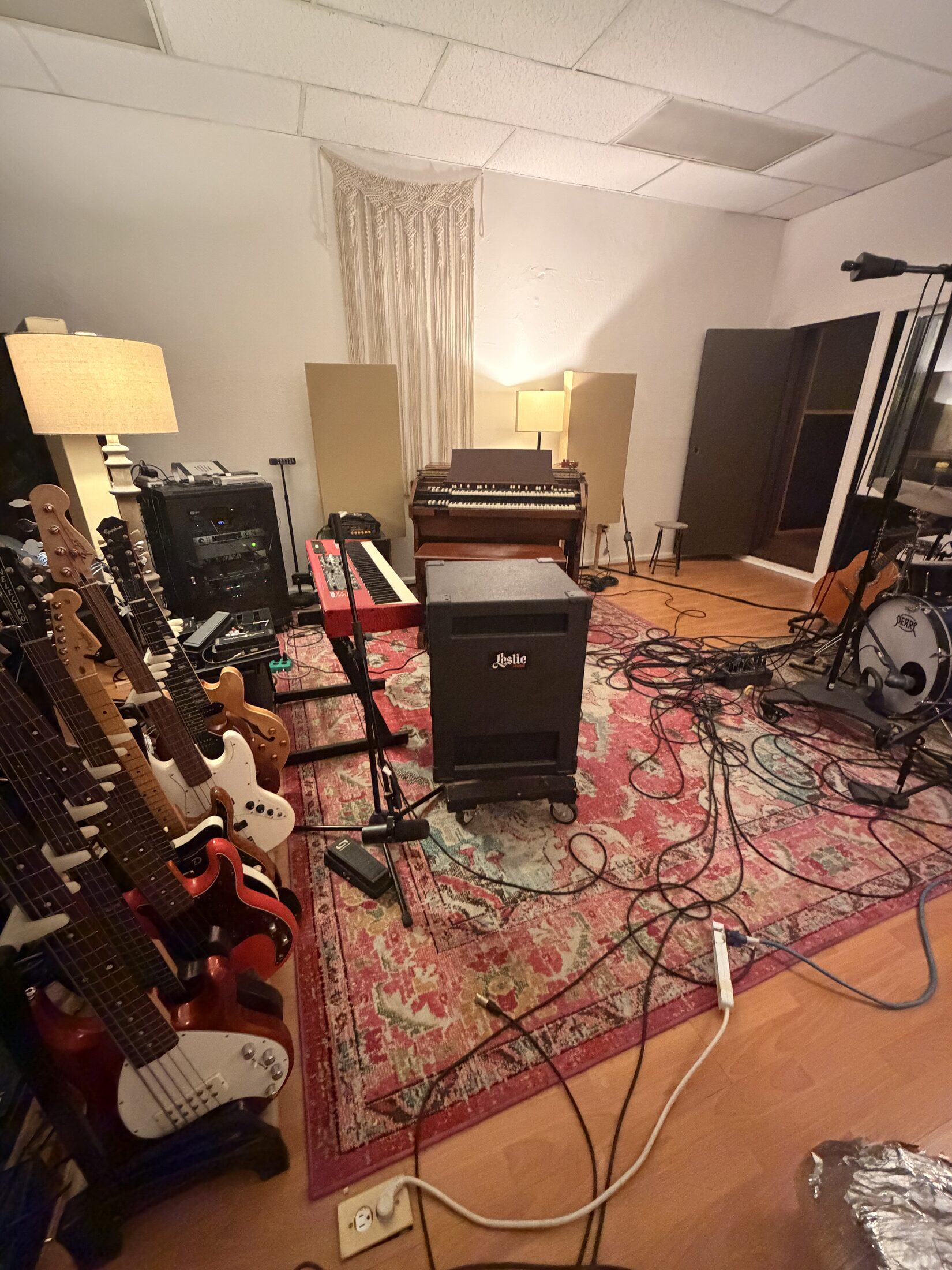 Wall of guitars beside the Hammond organ and Leslie cabinet