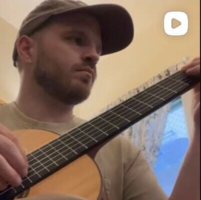 Phil Smith playing acoustic guitar